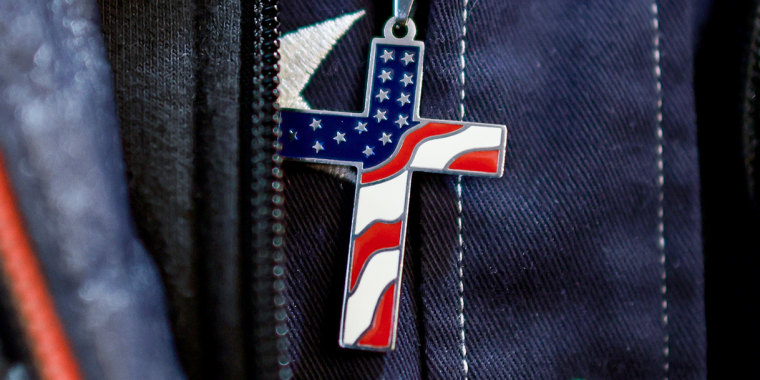 An American flag cross is worn
