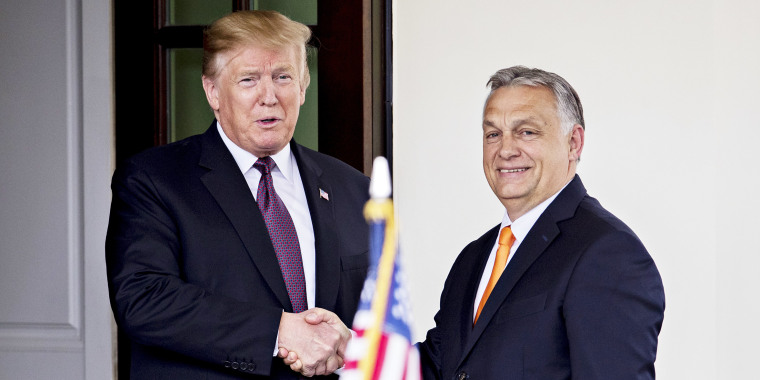 Donald Trump shakes hands with Viktor Orban.