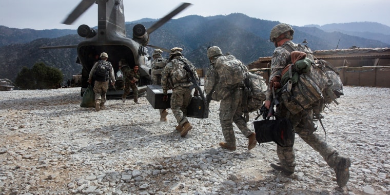 U.S. soldiers board an Army Chinook transport helicopter