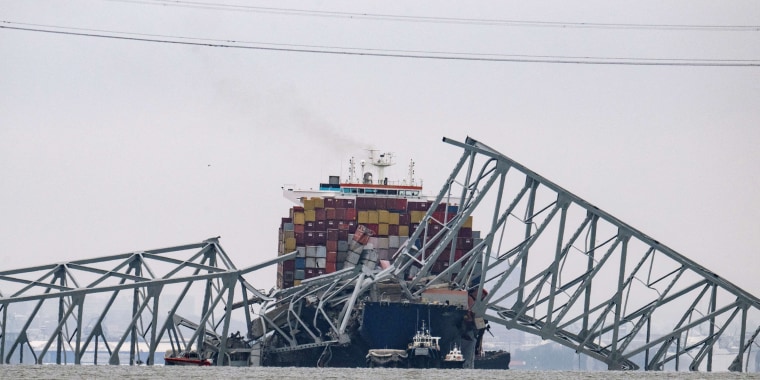 The collapsed Francis Scott Key Bridge lies on top of the container ship Dali in Baltimore