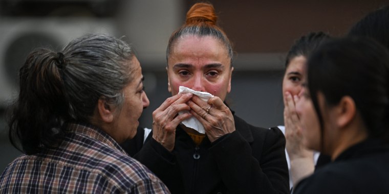 Relatives of victims react near the site of a fire in a residential building in Istanbul on April 2, 2024. 