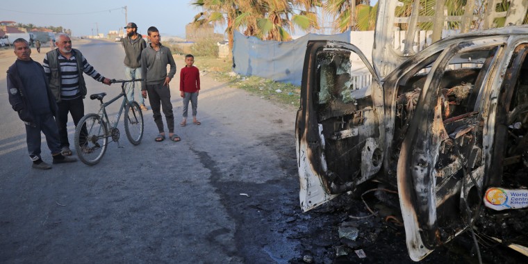 Palestinians look a vehicle in Deir Al-Balah, Gaza, on April 2, 2024, the day after it was destroyed by an Israeli airstrike that killed World Central Kitchen workers.