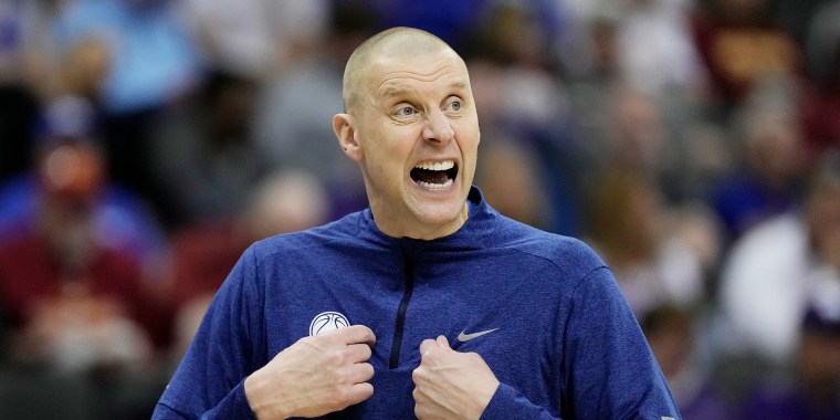 Mark Pope gestures during a game.