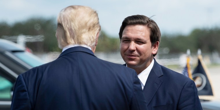 Ron DeSantis smiles as he greets then-President Donald Trump in 2020 