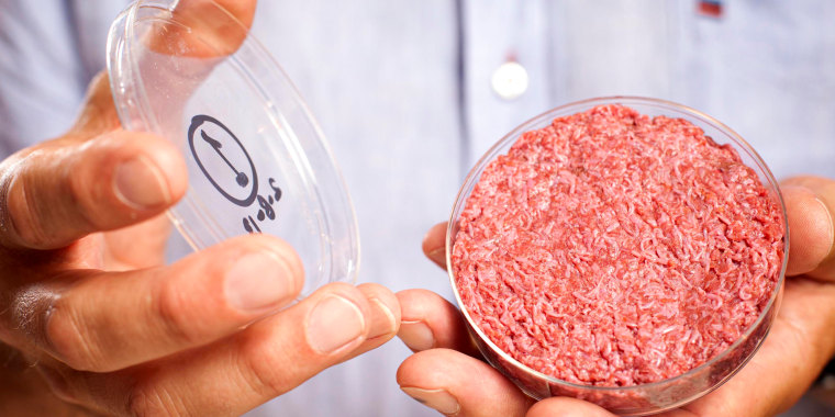 A person holds a lab-grown meat package.