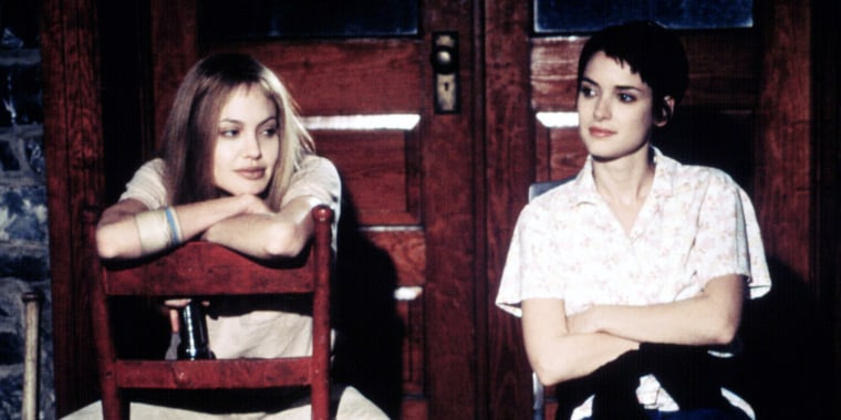 Angelina Jolie and Winona Ryder sitting on chairs