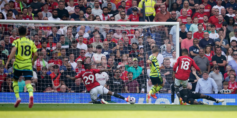 Arsenal's Leandro Trossard, centre, scores
