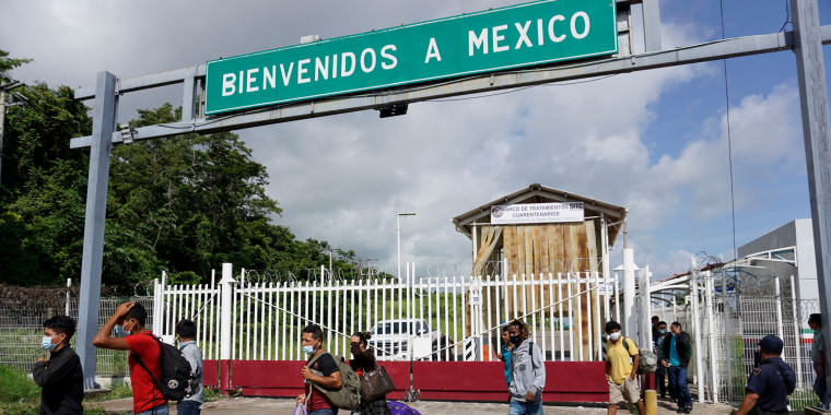 Migrants cross through the Mexico-Guatemala border
