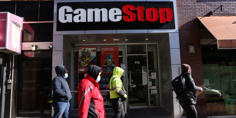 People walk passed a GameStop store in Brooklyn.
