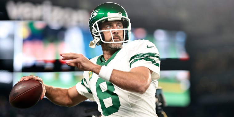 Aaron Rodgers passes as he warms up prior to a game