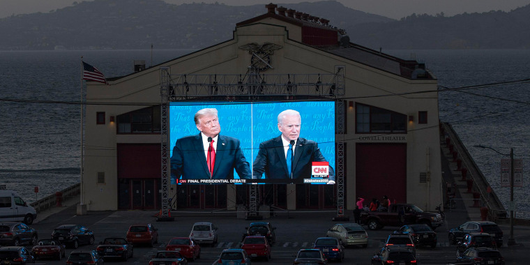 Car parked outside a theater with a split screen of the the debate
