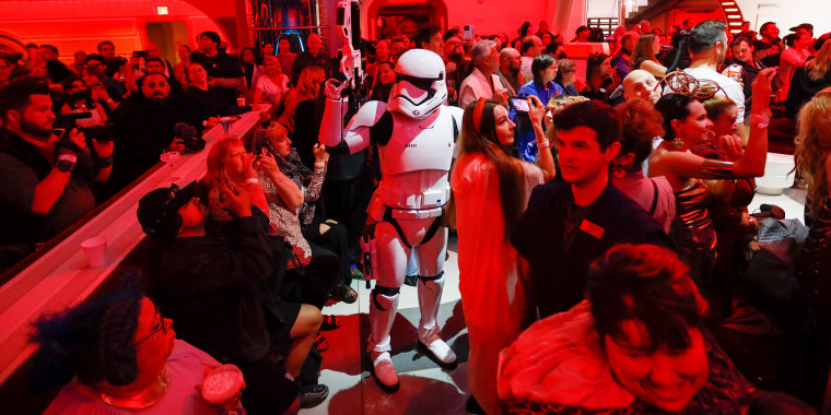 A First Order Stormtrooper patrols through the crowd