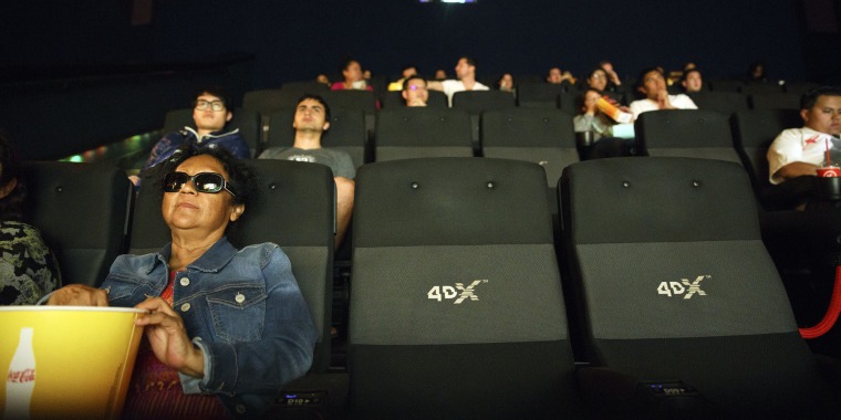 Audience members sit inside a 4DX theater at the Regal Cinemas L.A. LIVE Stadium 14 movie theater in Los Angeles.