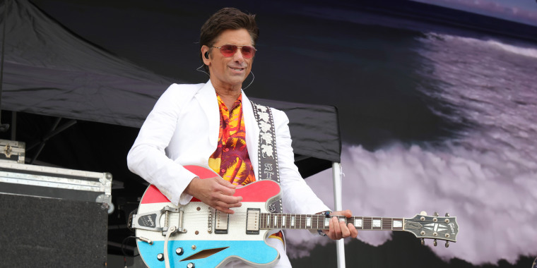 John Stamos plays the guitar on stage with The Beach Boys during Sea.Hear.Now in Asbury Park, N.J.