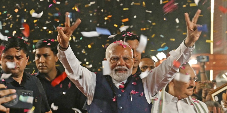 India's Prime Minister Narendra Modi flashes victory signs