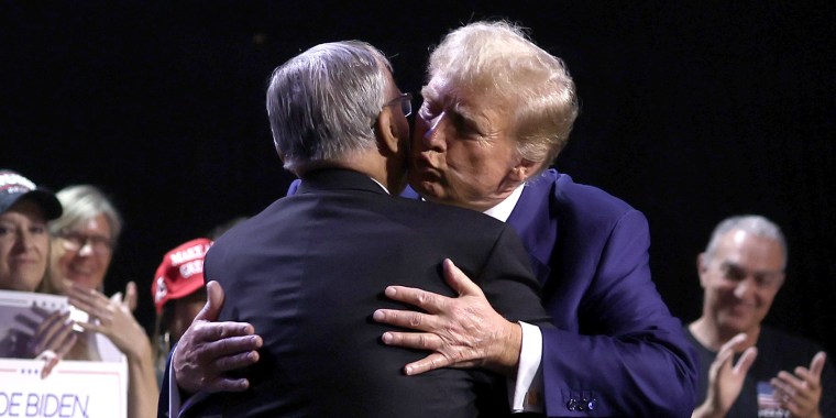 Donald Trump, right, hugs Joe Arpaio during a Turning Point PAC town hall at Dream City Church in Phoenix