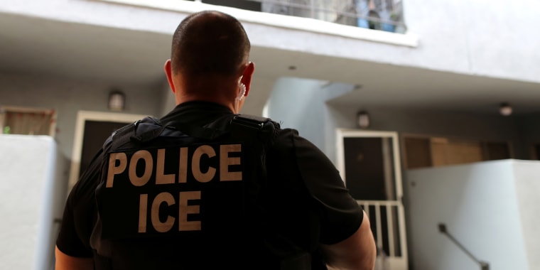 A U.S. Immigration and Customs Enforcement (ICE) officer at a home in Hawthorne, Calif.