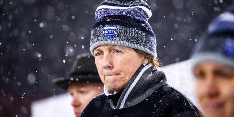 Katey Stone looks on as snow falls