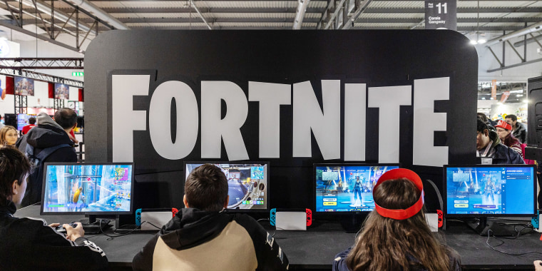 People play Fortnite video games at Nintendo Switch's stand