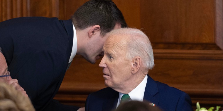 Jacob Spreyer, personal aide, speaks to the president during the annual Friends Of Ireland Speaker Luncheon at the Capitol on March 15, 2023.