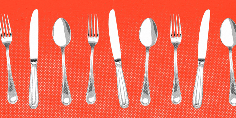 Forks, knives, and spoons lined up against a red background.