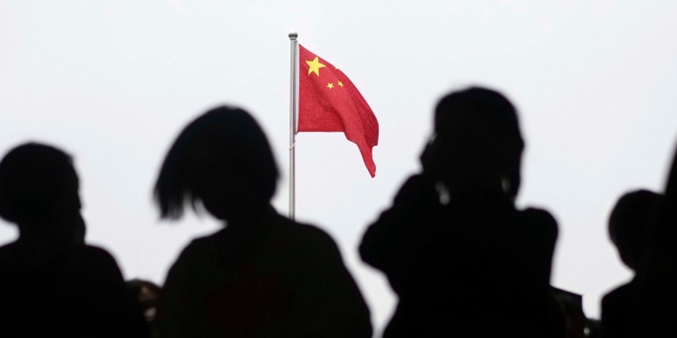 A Chinese flag is raised in Tiananmen Square 