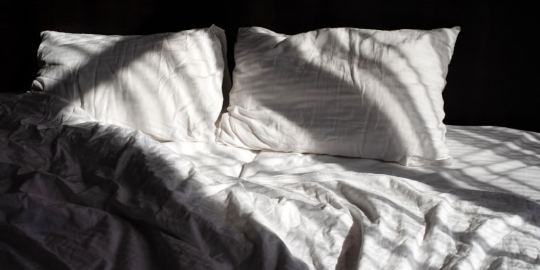 Bed with white bed linen. Empty bed. Bedroom.