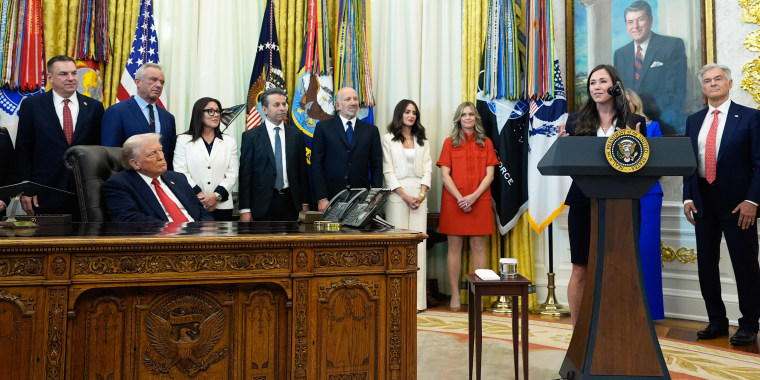 President Donald Trump listens as Sen. Katie Britt, R-Ala., speaks in the Oval Office of the White House.