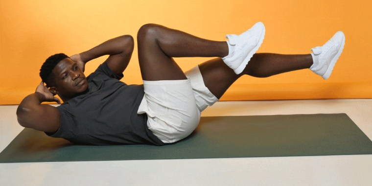 A man performing a bicycle crunch.