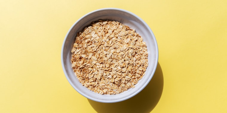 Oat Flakes in a Bowl Yellow Background