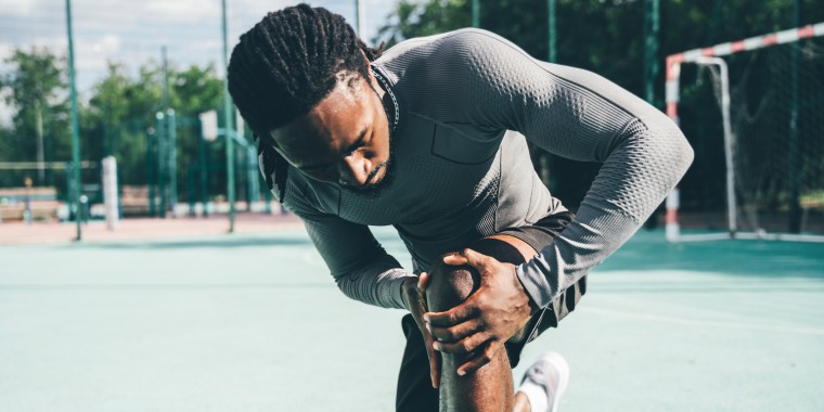 Active sportsman having a knee pain during training