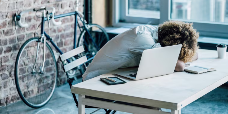Young man lying on desk
