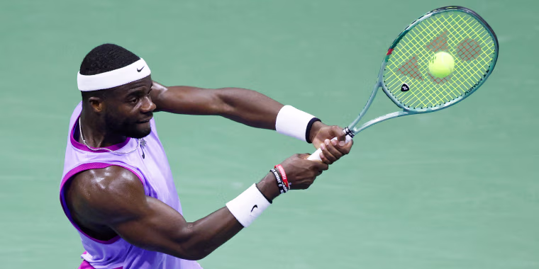 Frances Tiafoe hits a return.