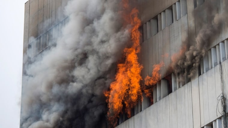 Bystanders watch in horror as people fall from burning office building in  Pakistan