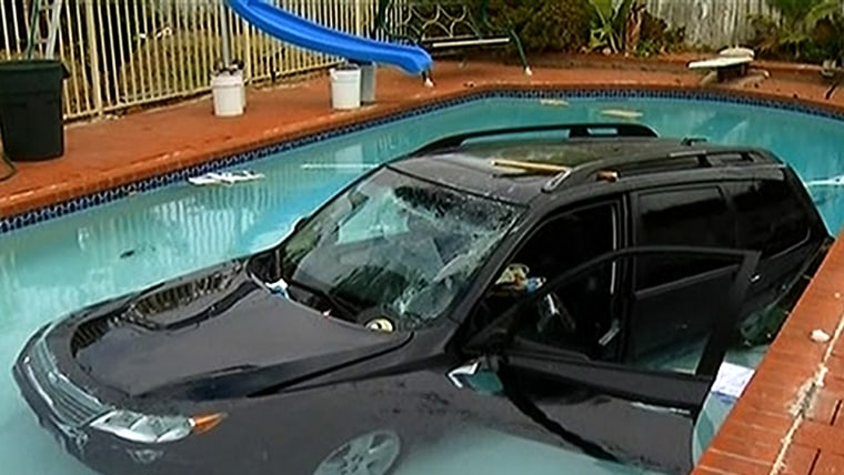 Woman crashes car through garage, 2 fences, lands in pool