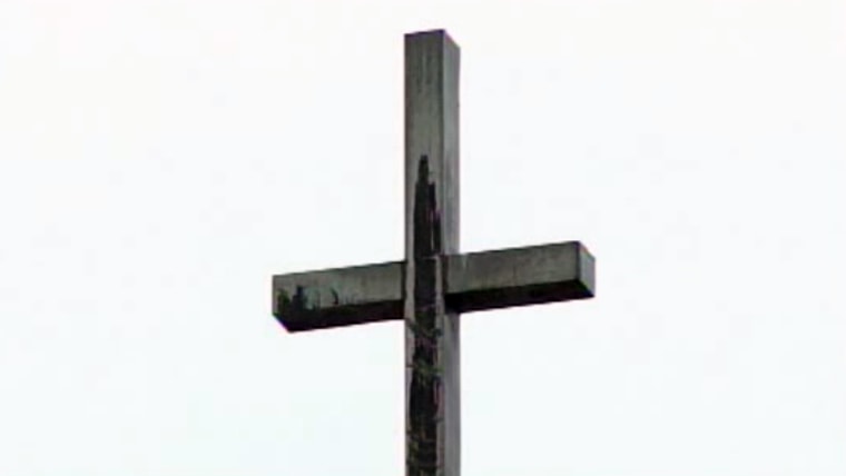 Faithful see Virgin Mary on water-stained cross