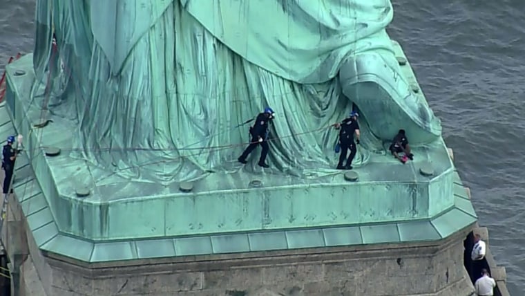 Liberty Island evacuated after woman scaled Statue of Liberty to ...