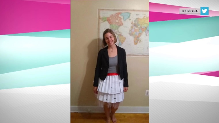 Doctoral student poses in skirt made out of rejection letters