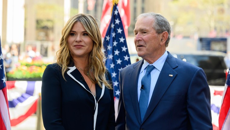 President George W. Bush and Laura Bush are surrounded by members of the New  Orleans Saints