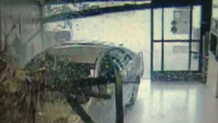 Car smashes through store window