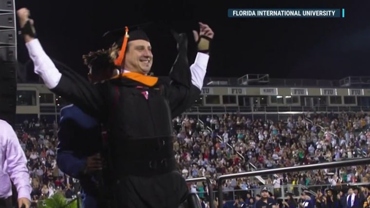 Paralyzed graduate walks to receive his Master's degree