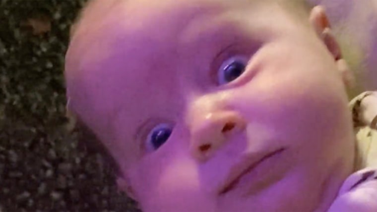 Baby gives a terrified look in the arms of big sister in funny video