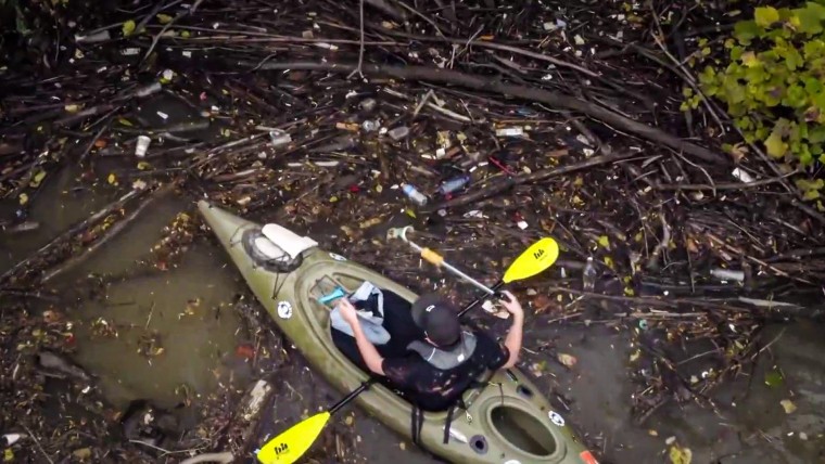 Man swaps fishing rod for trash bag to clean Cuyahoga River