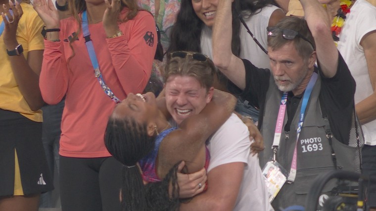Tara Davis-Woodhall's husband goes wild as she jumps to gold