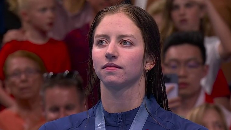 USA's Kate Douglass receives gold medal, stands atop podium