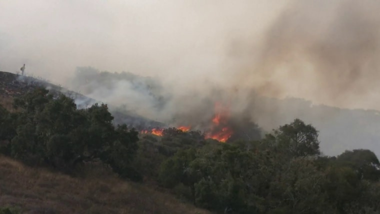 Massive wildfires burn out west as Canadian smoke moves east