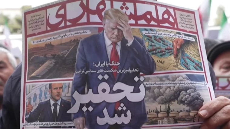 Iranians attend a mass funeral for officials killed in the war