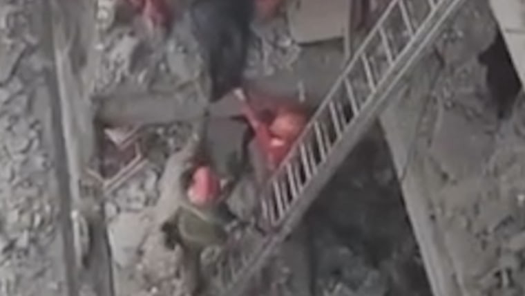 Rescue workers search rubble after airstrike in Tehran