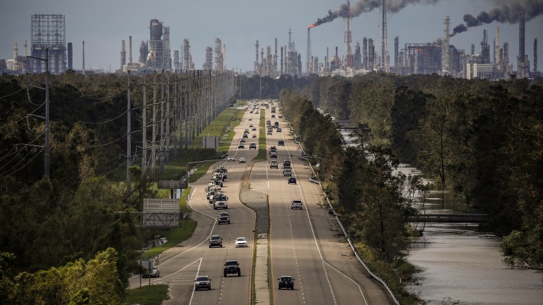 Traffic moves along a stretch of roads near the Royal Dutch Shell and Valero Energy's Norco refineries during a power outage caused by Hurricane Ida in LaPlace, La., on Aug. 30, 2021.