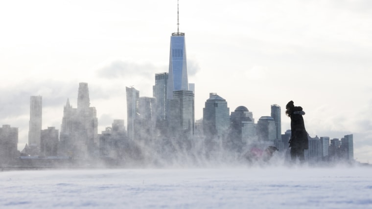 A person plays with a dog in Hoboken, New Jersey on Dec. 21, 2024. 